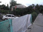 Автомобиль ВАЗ -  211440 превысил скорость, врезался в столб и выломал забор частного дома